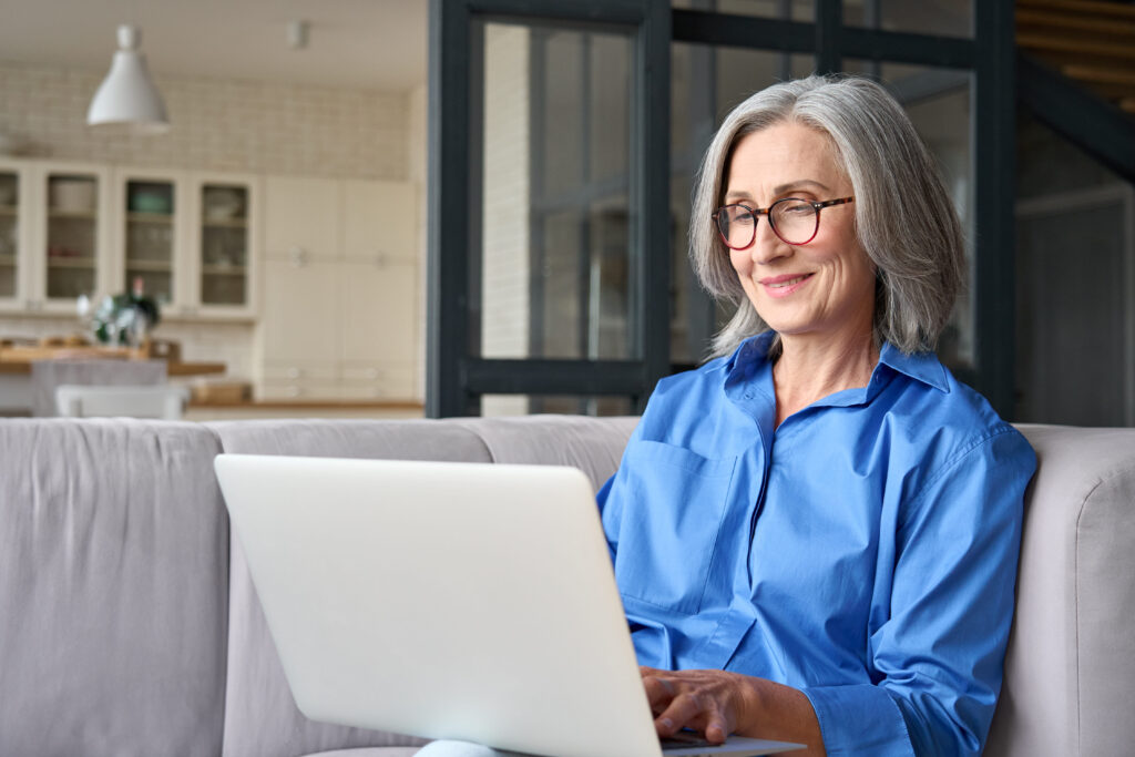 A woman on her laptop enjoys simplified access to helpful scheduling and information on her preferred hospital’s website.